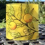 Fused glass free-standing hand-painted panel of oranges on foliage