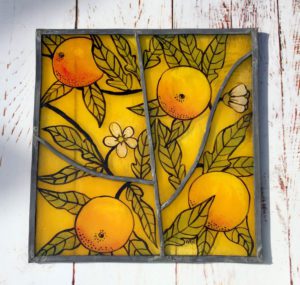 Finished glass panel featuring oranges motif
