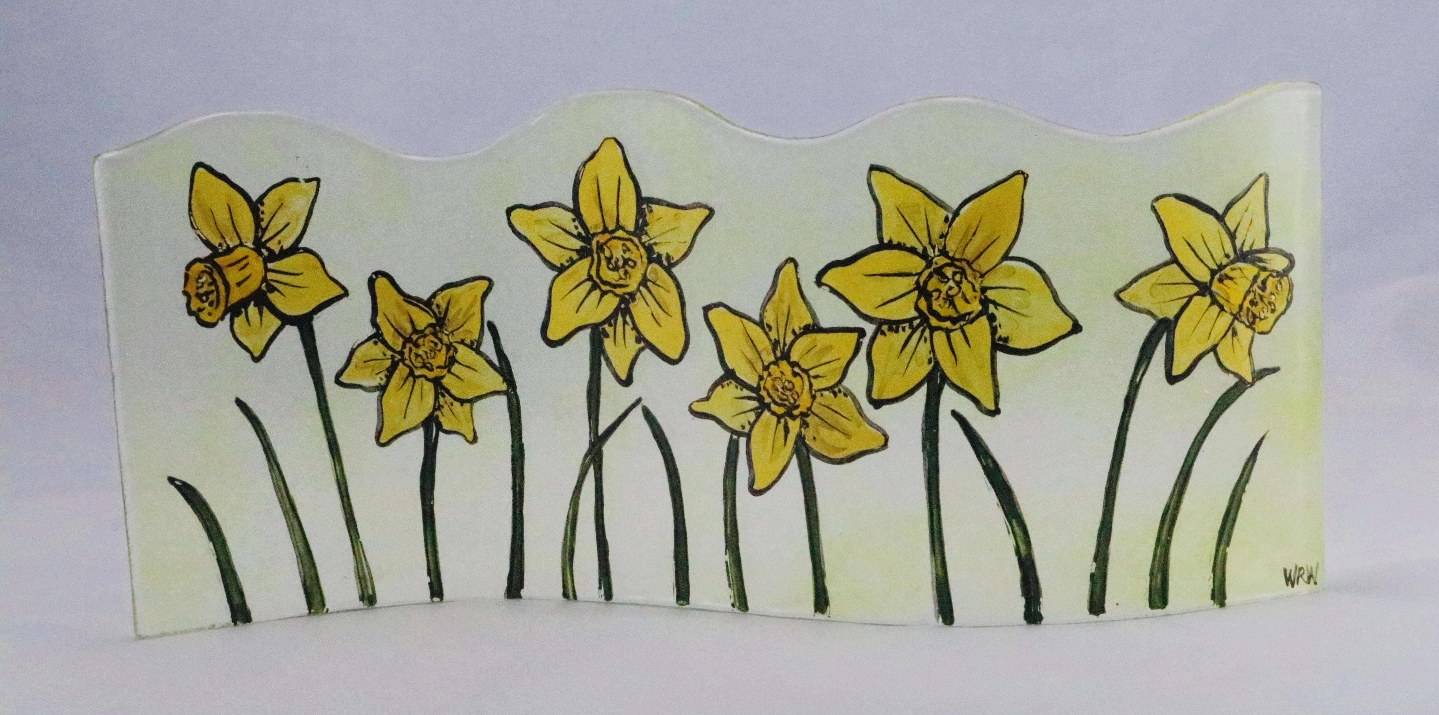 Long curved handpainted fused glass panel with daffodils on transparent spring green background