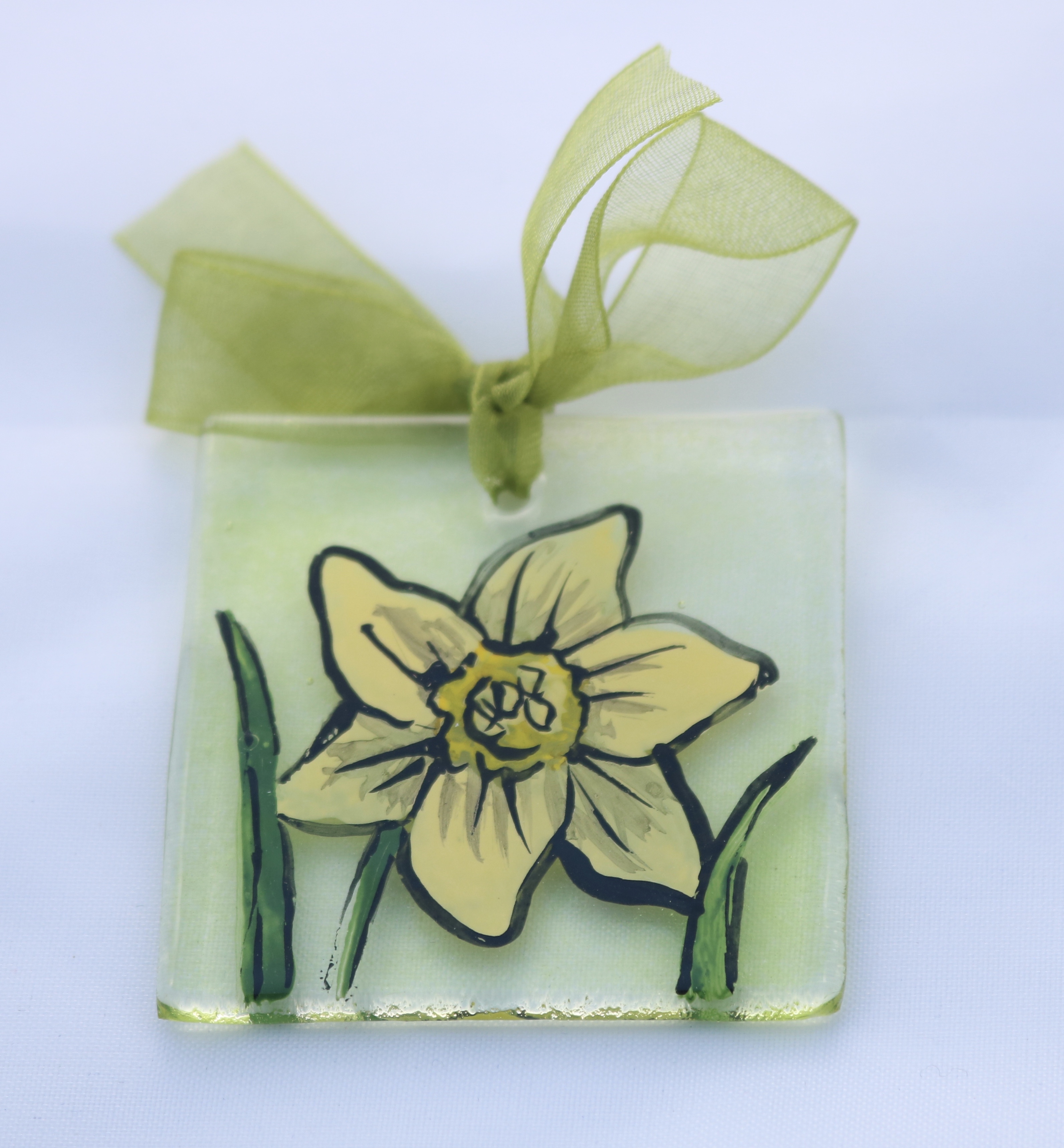 Hand painted daffodil on transparent green background, mounted on white greetings card