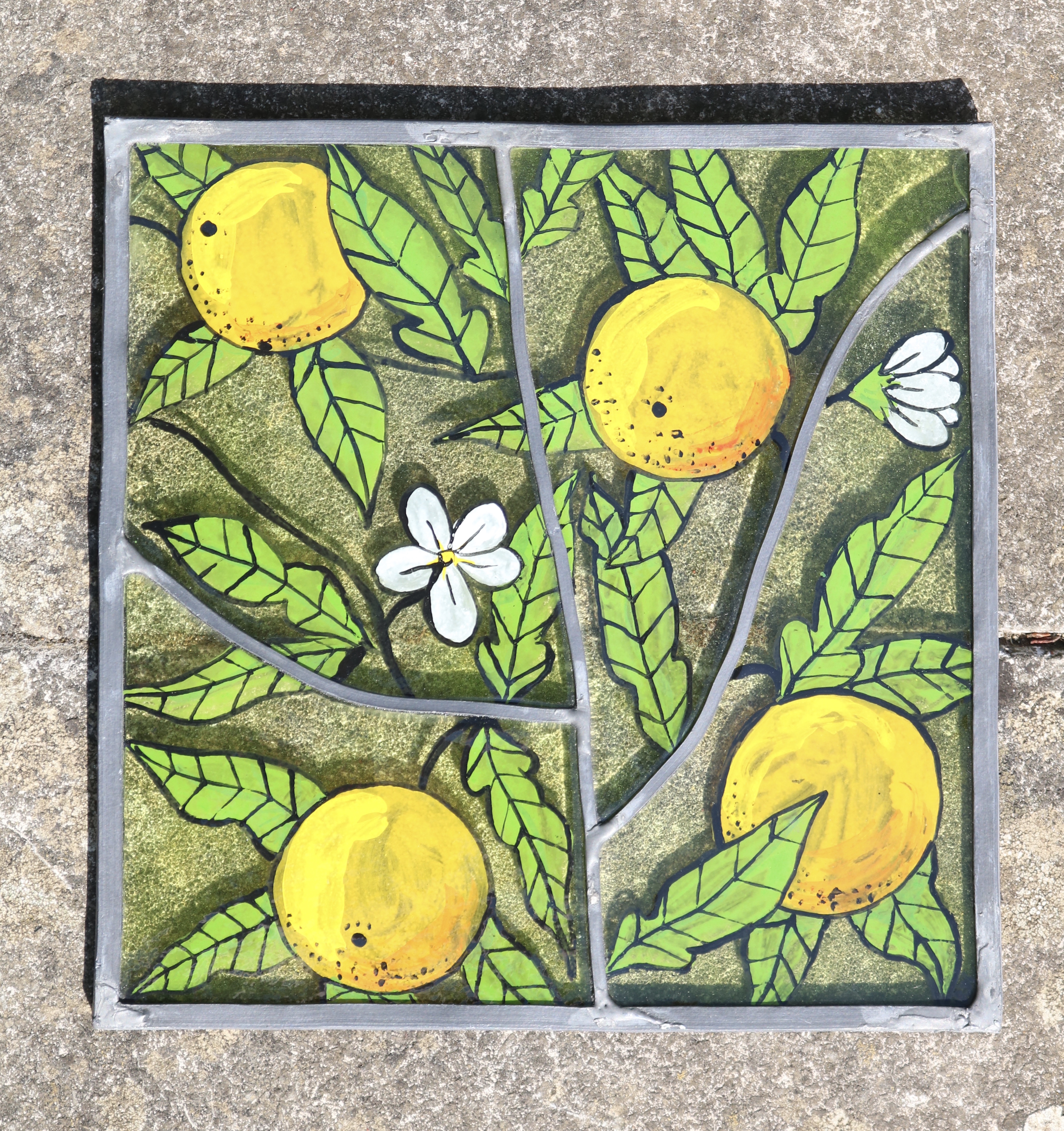 Handpainted oranges on green glass with leaded joints