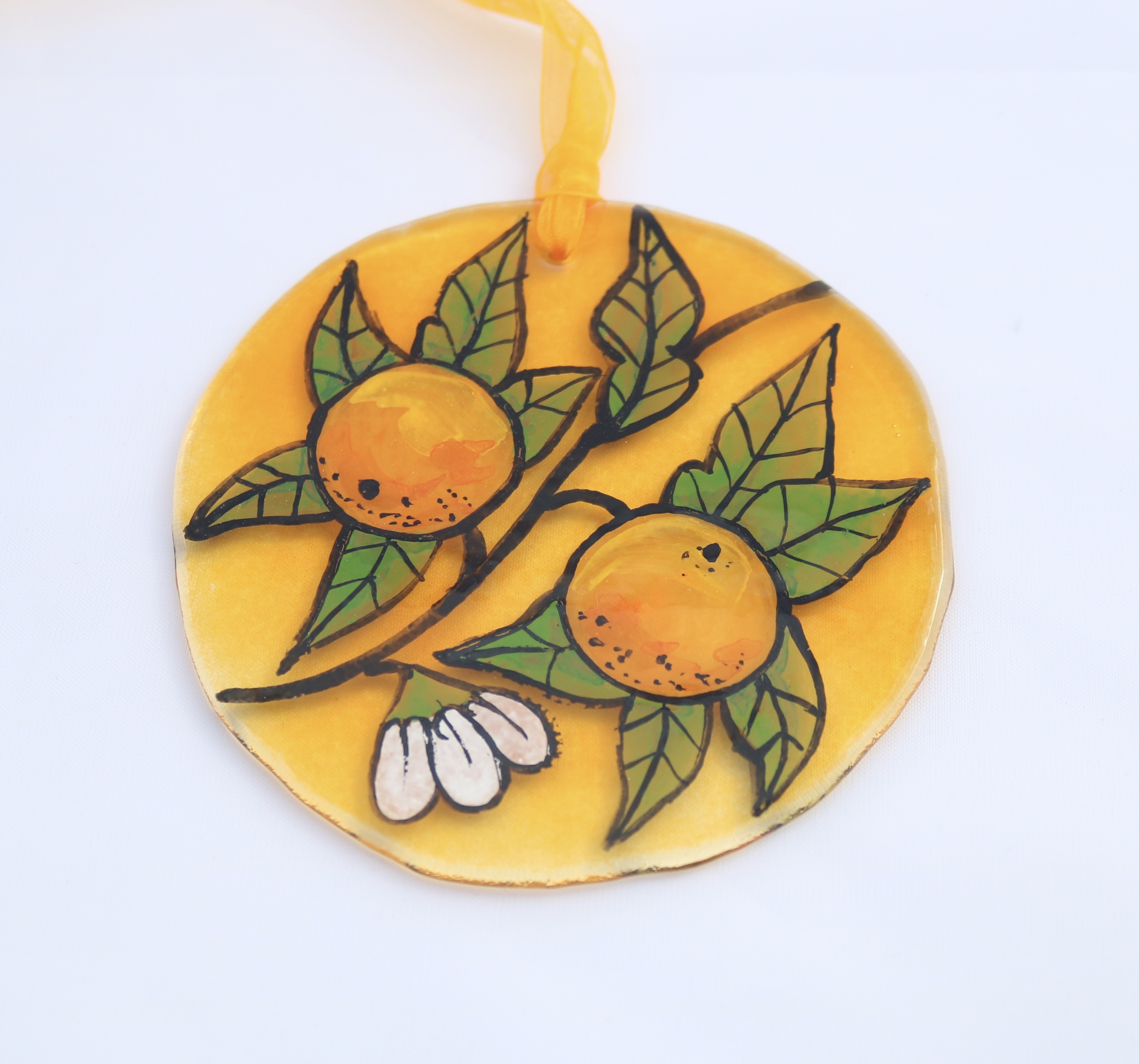 Handpainted oranges and foliage on fused glass circle