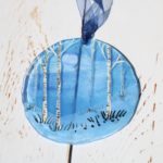 Blue suncatcher with Somerset winter design of silver birches and snowscape