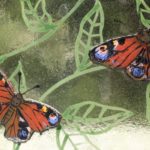 Close up showing handmade glass British peacock butterflies