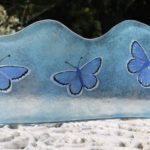 Long wavy glass panel with common blue butterflies design