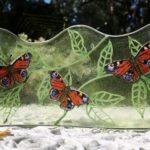 Transparent glass decorative panel with peacock butterflies design