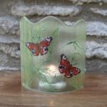 Fused glass panel with tealight candle behind it