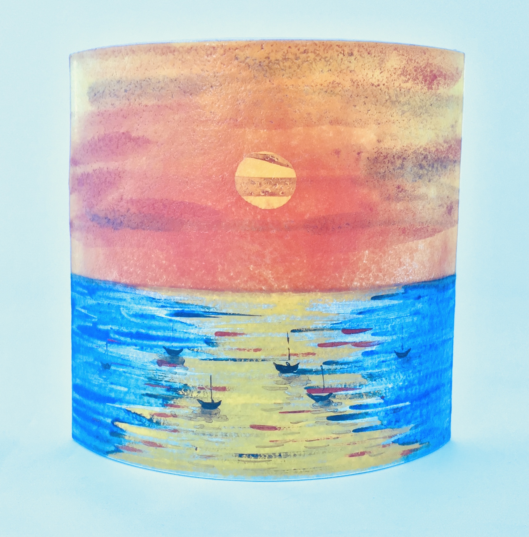 Short free-standing glass panel featuring sunset seascape, boat silhouettes