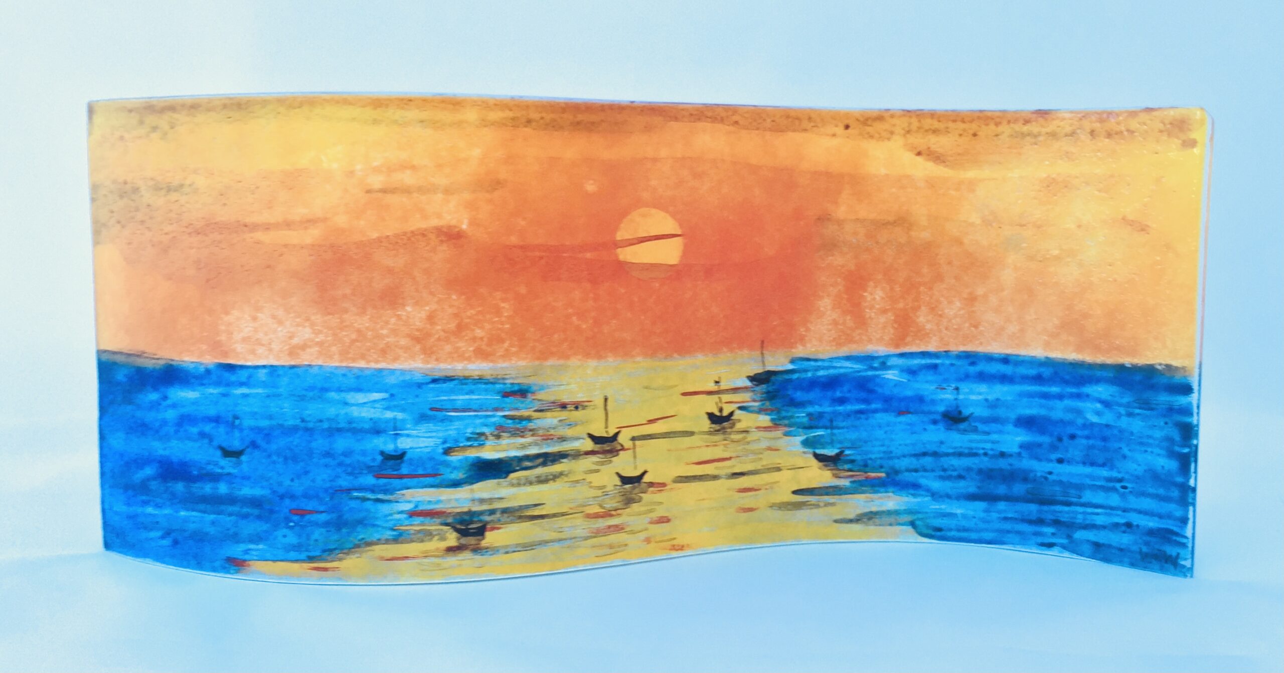 Long, wavy free-standing fused glass panel with sunset sea design